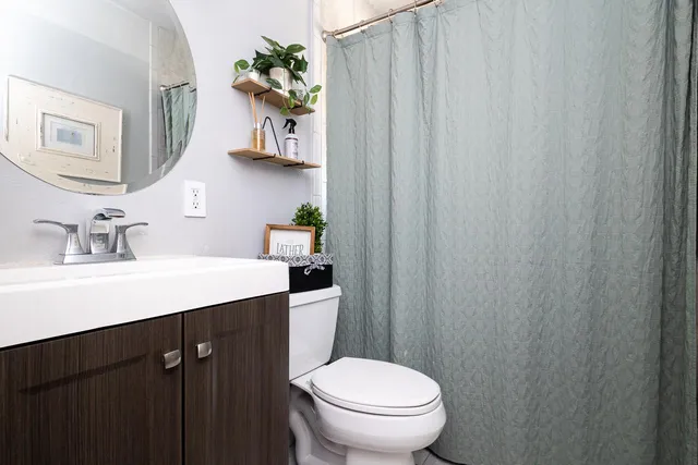 a bathroom with a sink a toilet and a mirror
