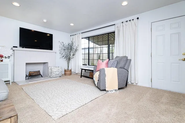 a living room with furniture and a fireplace