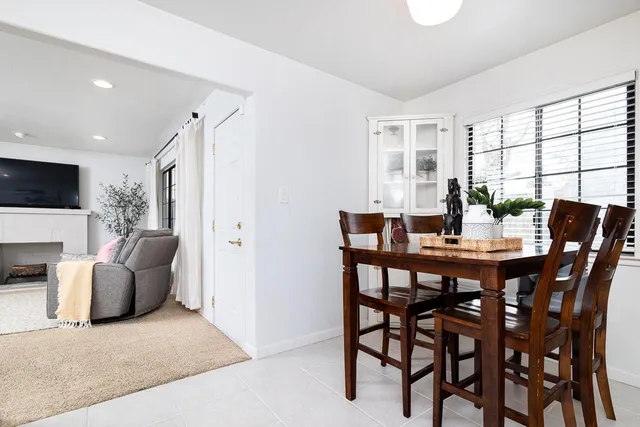 a view of a dining room with furniture and a large window