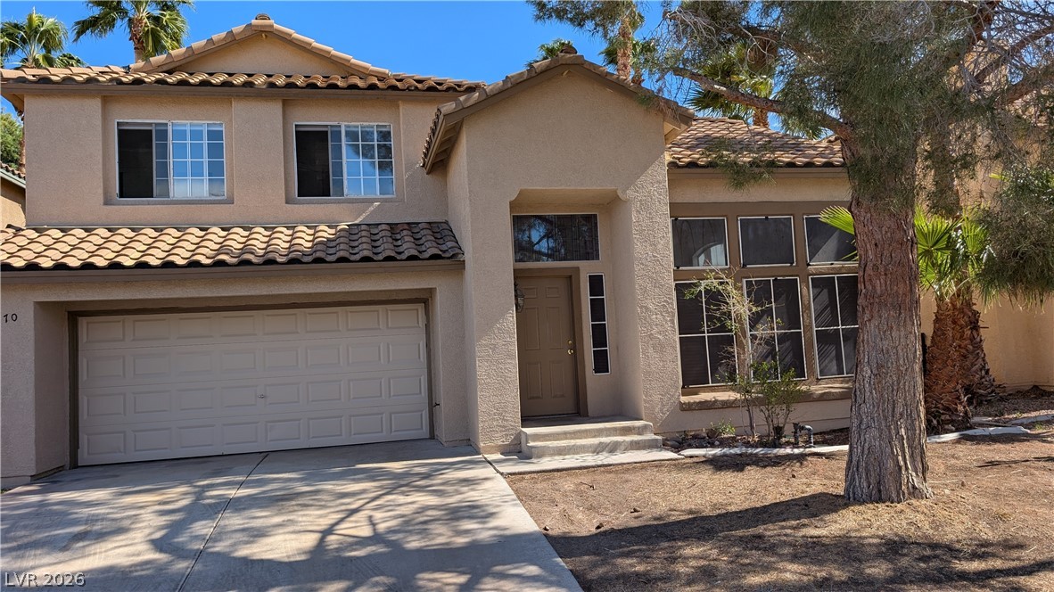2670 Ridgewater Circle Henderson, NV 89074 - Photo 2 of 22 This charming residence features an attached garage and a welcoming entrance, set against a sunny landscape.