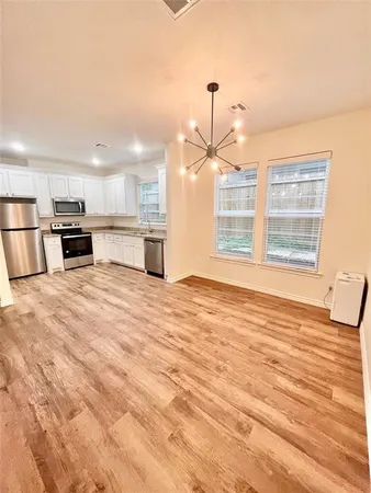 a view of a kitchen with a stove cabinets and wooden floor