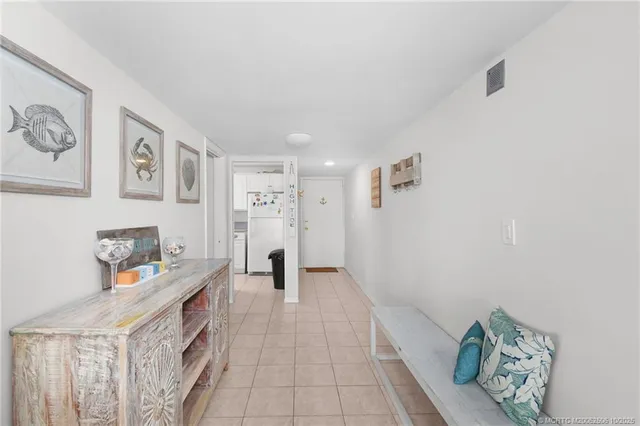 a workspace with white wall cabinets and a window