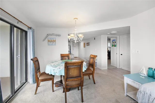 a living room with furniture a chandelier and a flat screen tv