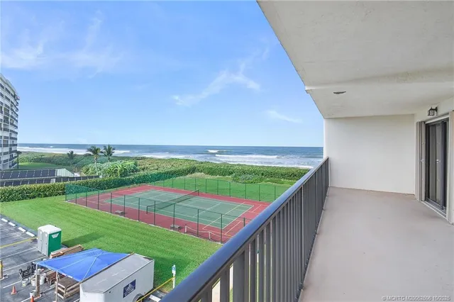 a view of a balcony with wooden floor and fence