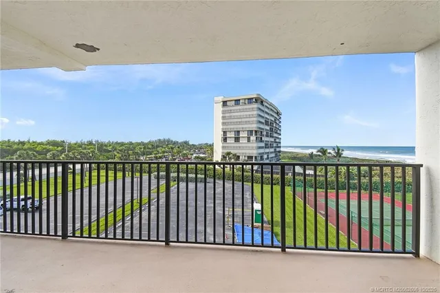a balcony with wooden floor and city view