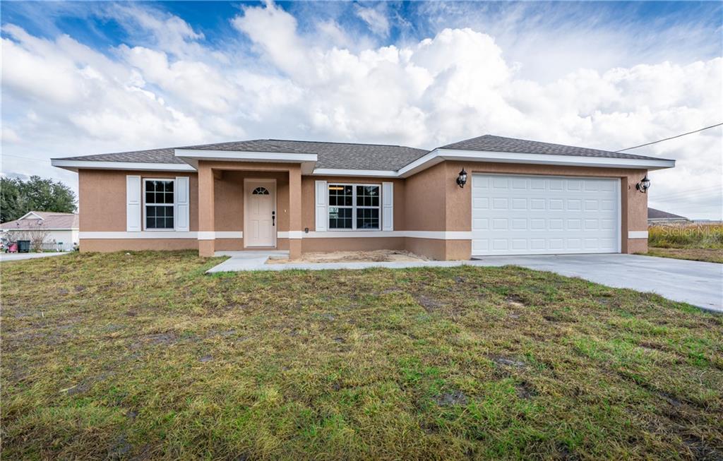 66 Cedar Road Ocala, FL 34472 - Photo 1 of 1 a front view of a house with garden