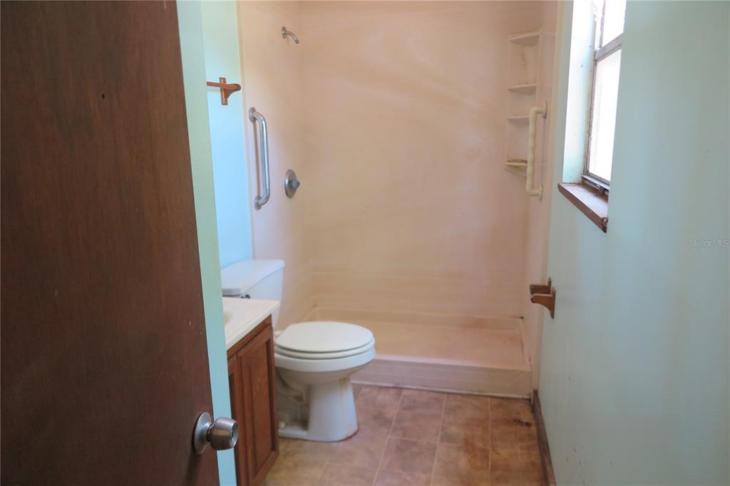153-UNIT Ranch Road San Mateo, FL 32187 - Photo 14 of 34 a bathroom with a toilet and a shower