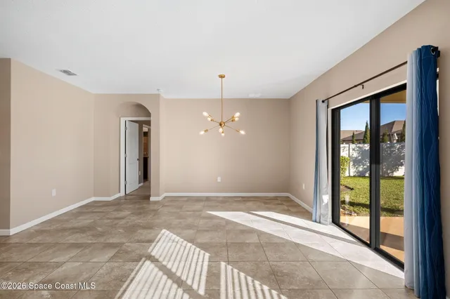 a view of an empty room with glass door