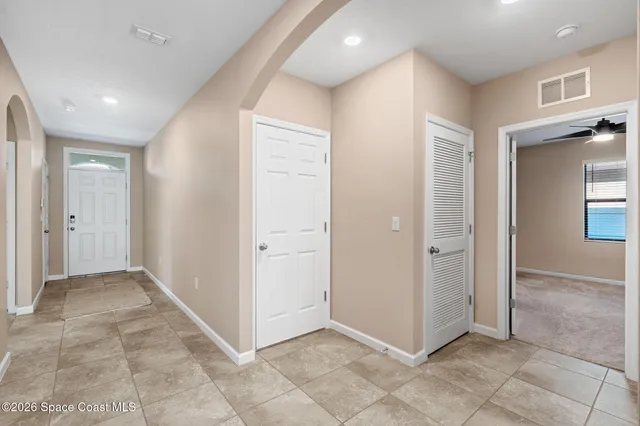 an empty room with entrance and windows