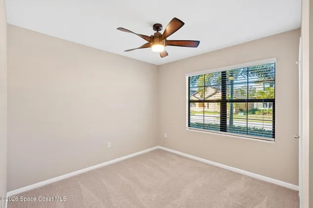 a bathroom with a granite countertop bathtub shower sink vanity mirror and toilet