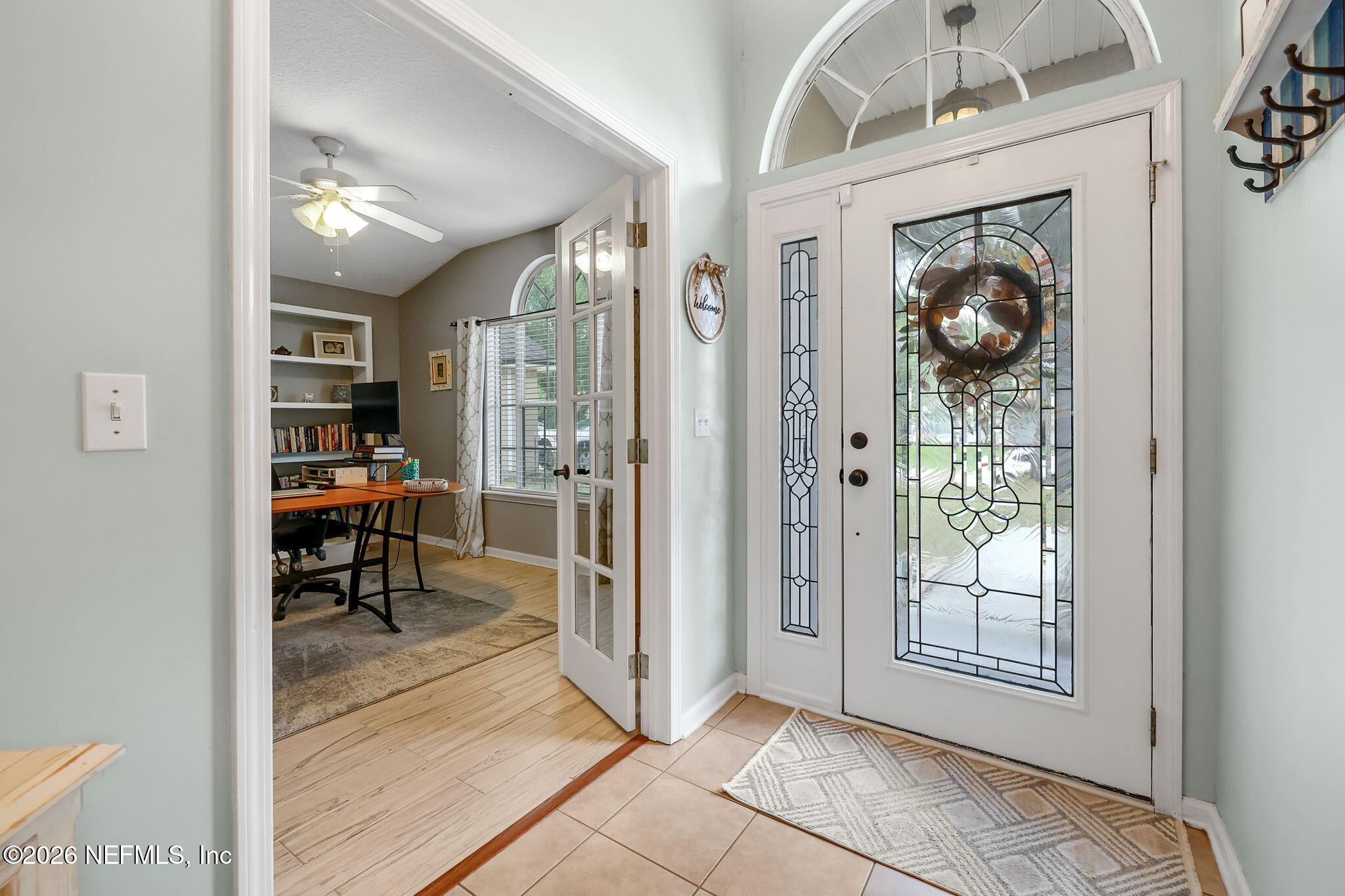 4320 Rye Court St. Johns, FL 32259 - Photo 6 of 60 a view of a hallway that has a dining table and chandelier