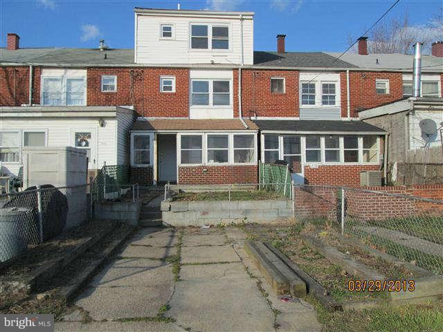 2106 Jasmine Road Baltimore, MD 21222 - Photo 2 of 17 a view of a brick building next to a yard