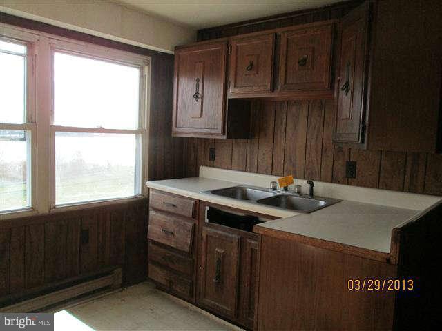 2106 Jasmine Road Baltimore, MD 21222 - Photo 16 of 17 a kitchen with a sink a stove and a microwave