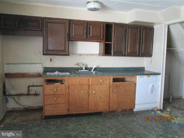2106 Jasmine Road Baltimore, MD 21222 - Photo 6 of 17 a kitchen with granite countertop cabinets and window