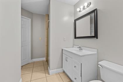 3718 Southwest Masilunas Street Port St. Lucie, FL 34953 - Photo 12 of 20 a bathroom with a toilet sink and mirror