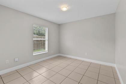 3718 Southwest Masilunas Street Port St. Lucie, FL 34953 - Photo 13 of 20 a view of an empty room with a window