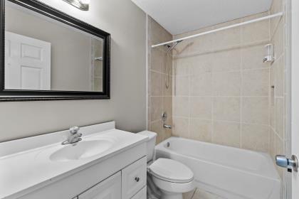 3718 Southwest Masilunas Street Port St. Lucie, FL 34953 - Photo 14 of 20 a bathroom with a granite countertop sink a toilet and shower