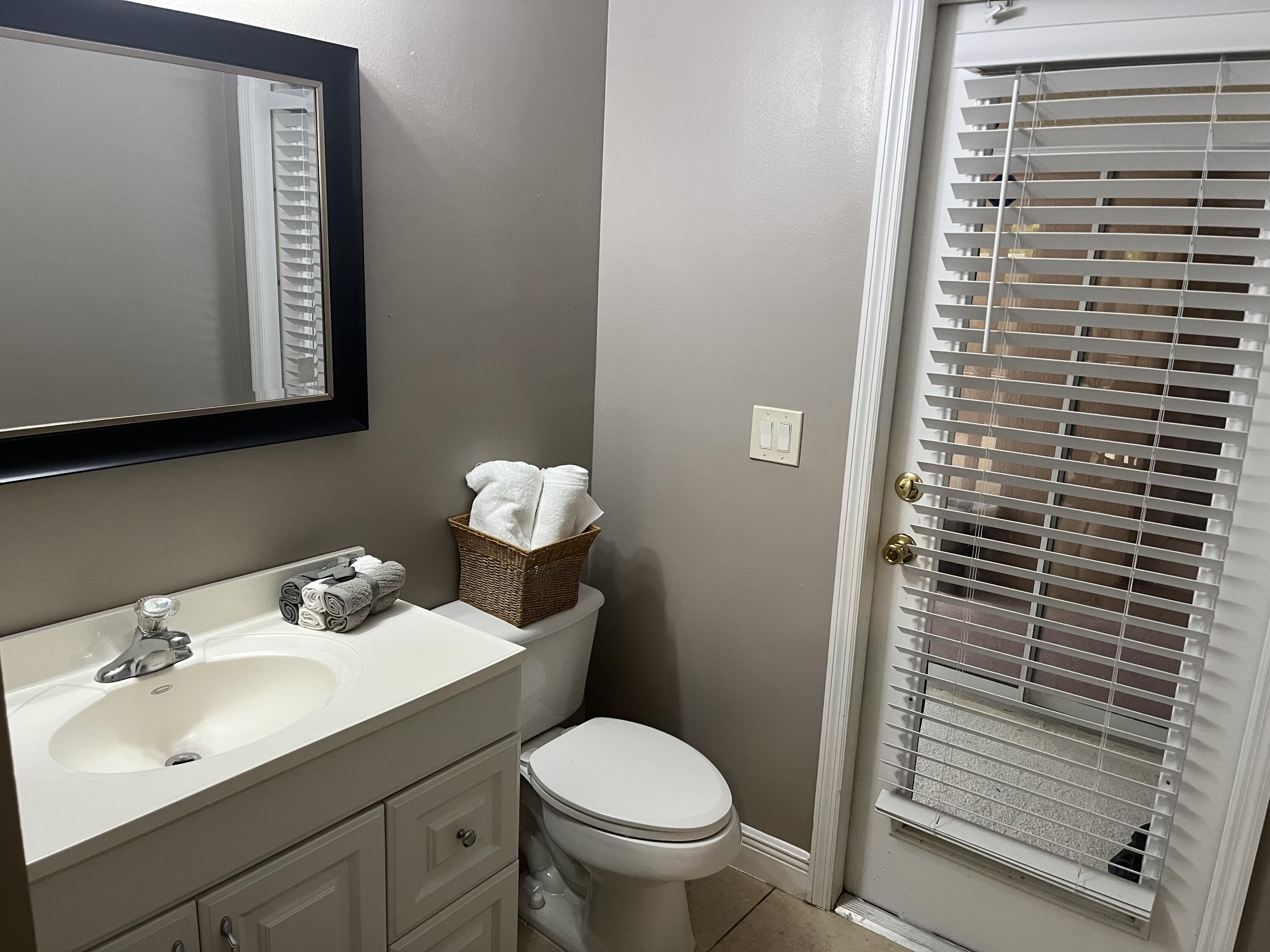 3718 Southwest Masilunas Street Port St. Lucie, FL 34953 - Photo 16 of 20 a bathroom with a sink toilet and mirror