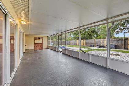 3718 Southwest Masilunas Street Port St. Lucie, FL 34953 - Photo 18 of 20 a view of hallway with wooden floor and fence