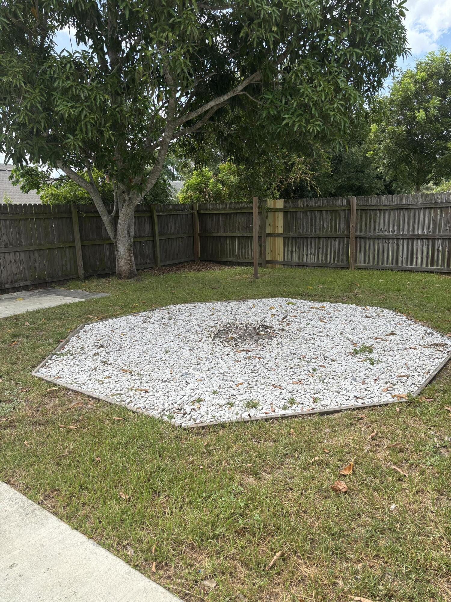 3718 Southwest Masilunas Street Port St. Lucie, FL 34953 - Photo 20 of 20 a view of a yard with large trees