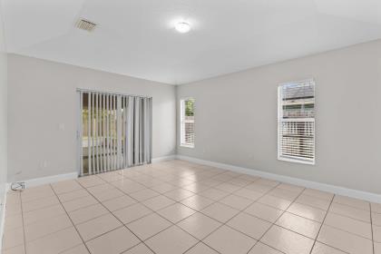 3718 Southwest Masilunas Street Port St. Lucie, FL 34953 - Photo 6 of 20 a view of an empty room with a window