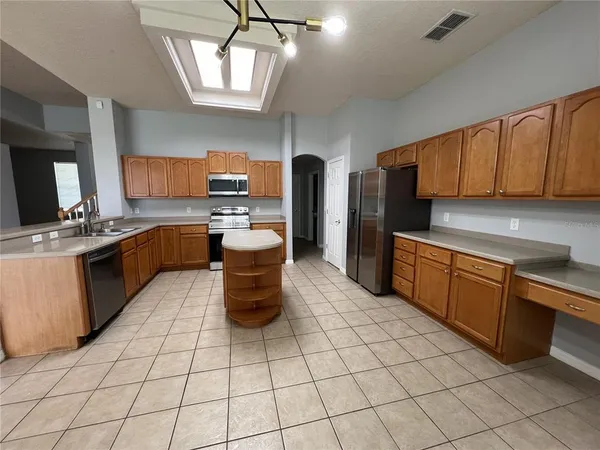 a kitchen with a sink a stove cabinets and counter space