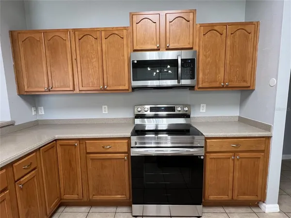 a kitchen with granite countertop a stove and a microwave