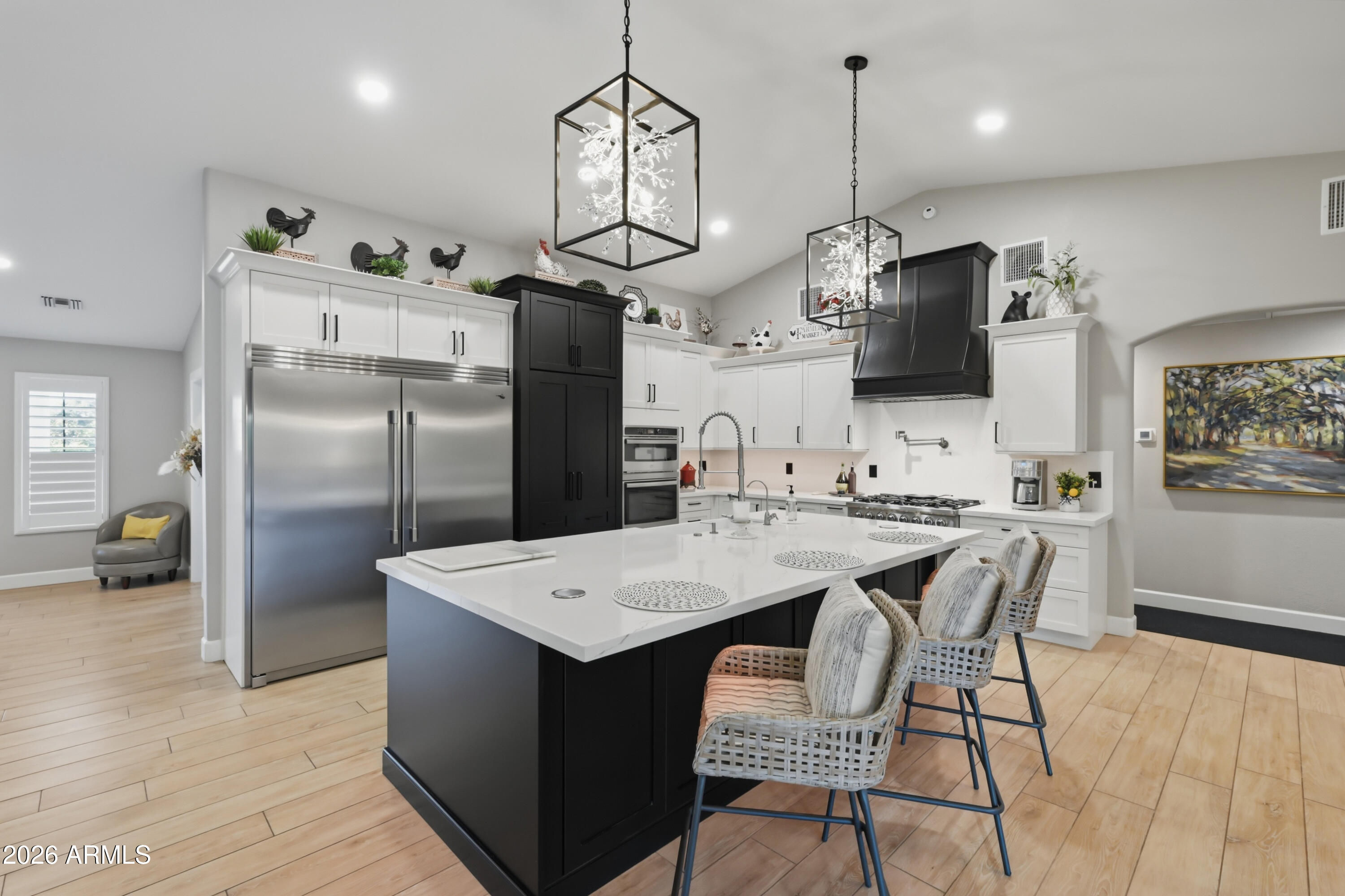 5213 West Dobbins Road Laveen, AZ 85339 - Photo 26 of 69 a kitchen with stainless steel appliances granite countertop a refrigerator a sink dishwasher a stove and a dining table with wooden floor