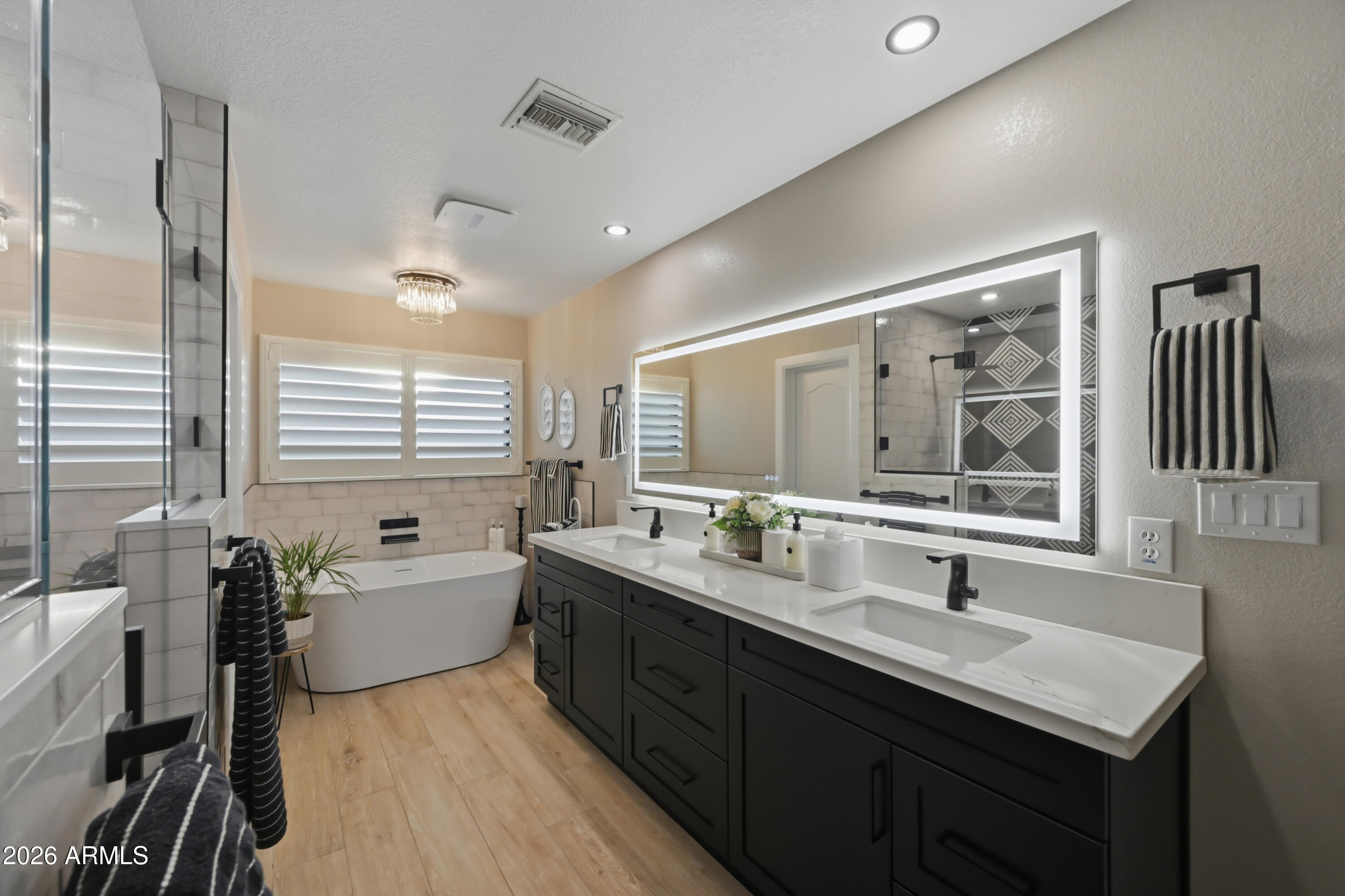 5213 West Dobbins Road Laveen, AZ 85339 - Photo 37 of 69 a bathroom with a double vanity sink tub and a mirror