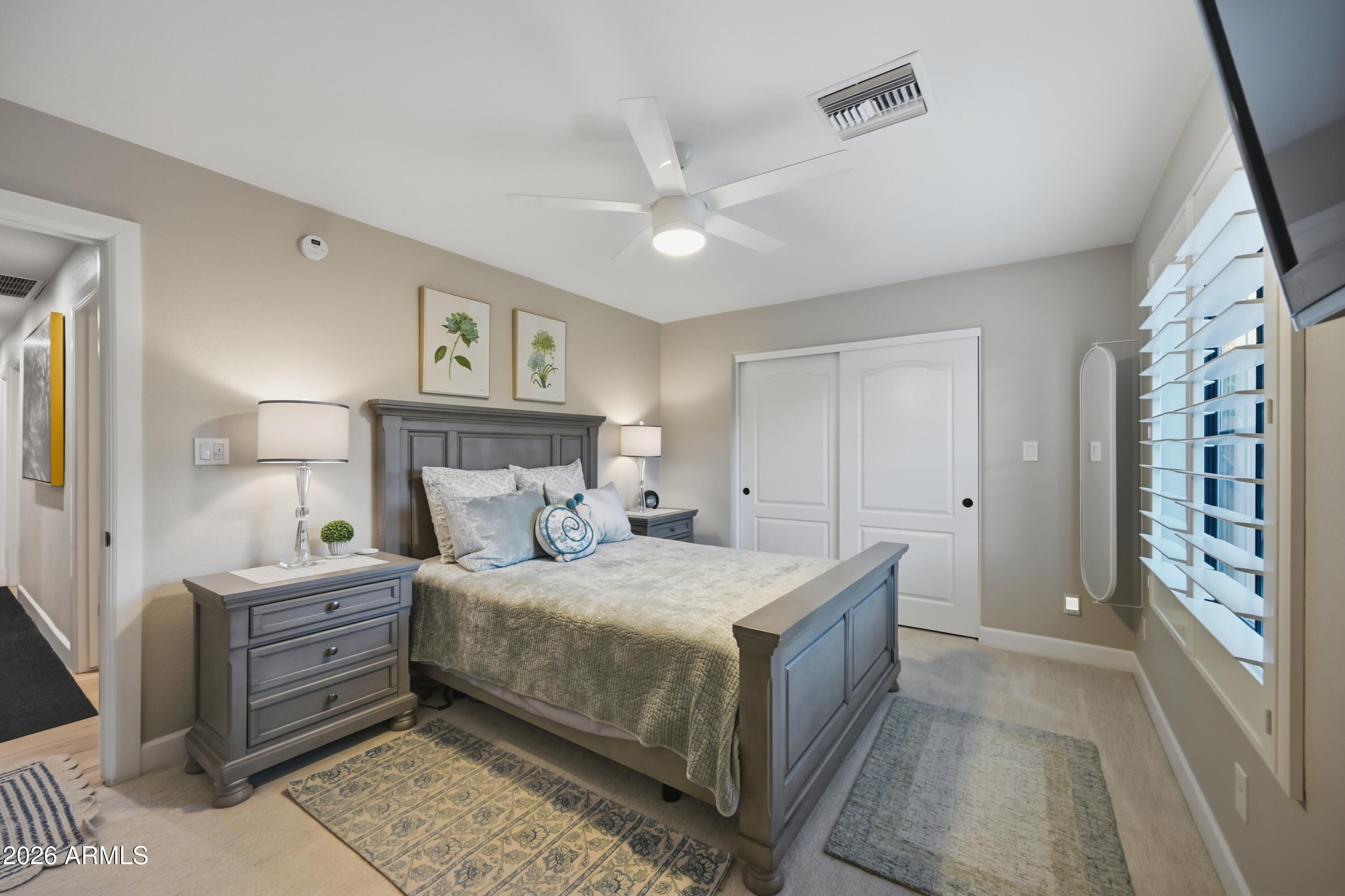 5213 West Dobbins Road Laveen, AZ 85339 - Photo 41 of 69 a bedroom with a large bed and a chandelier