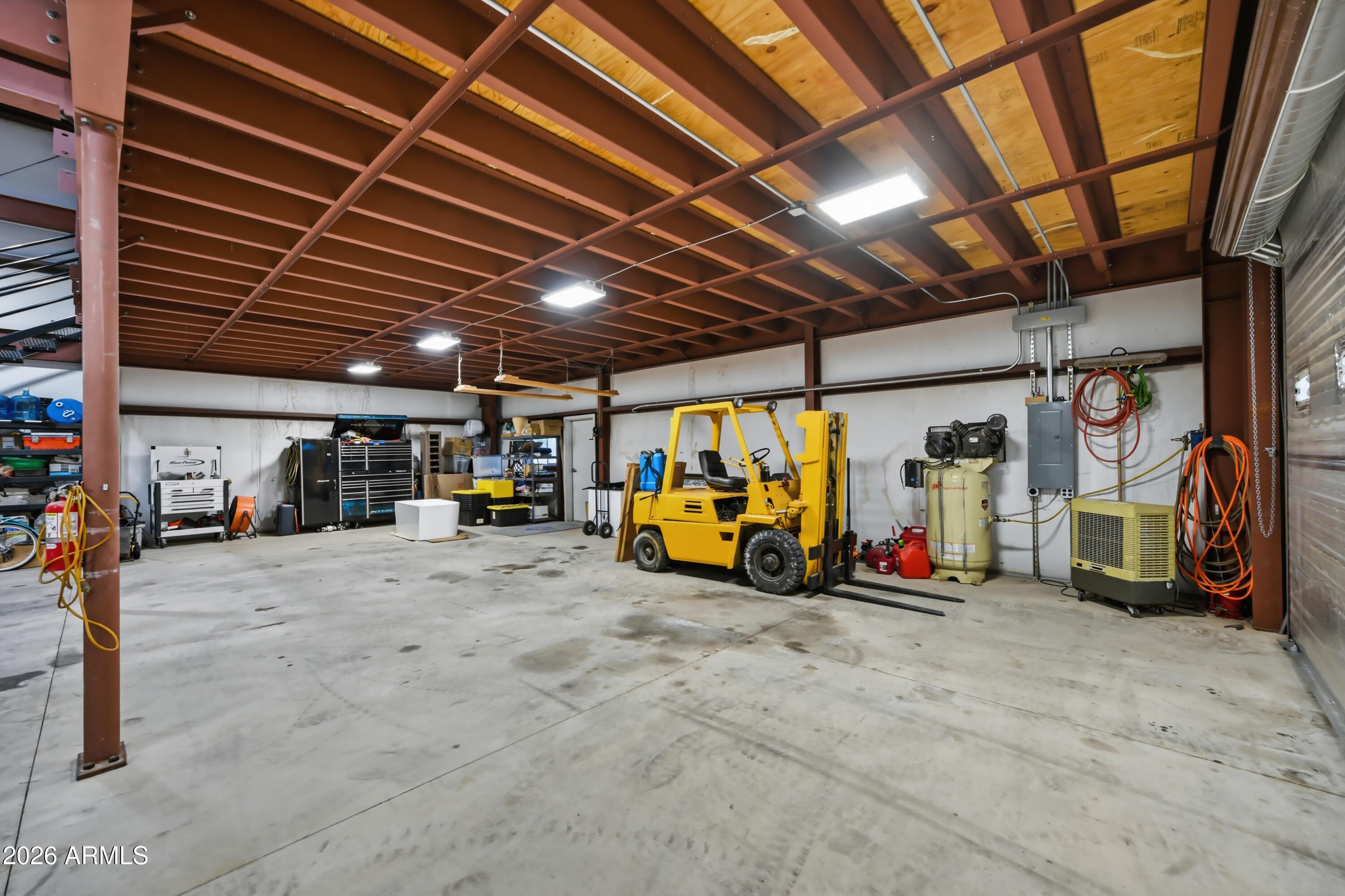 5213 West Dobbins Road Laveen, AZ 85339 - Photo 53 of 69 a view of a garage with a bike and car