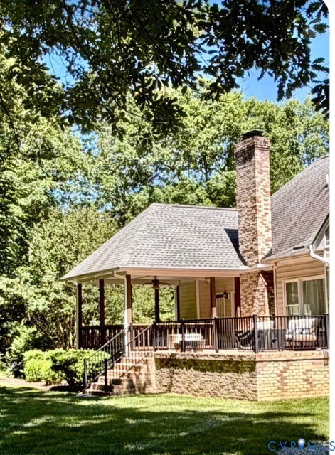 12123 Deer Ridge Court Ashland, VA 23005 - Photo 4 of 63 a patio with table and chairs and a umbrella