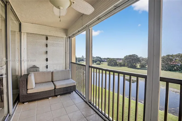 a balcony with furniture and view of bathroom