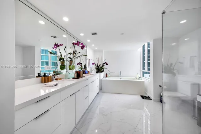 a large white kitchen with lots of counter top space