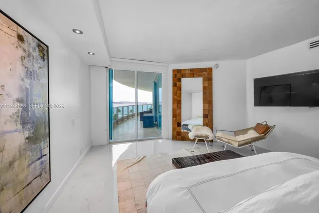 a living room with furniture tv and large window