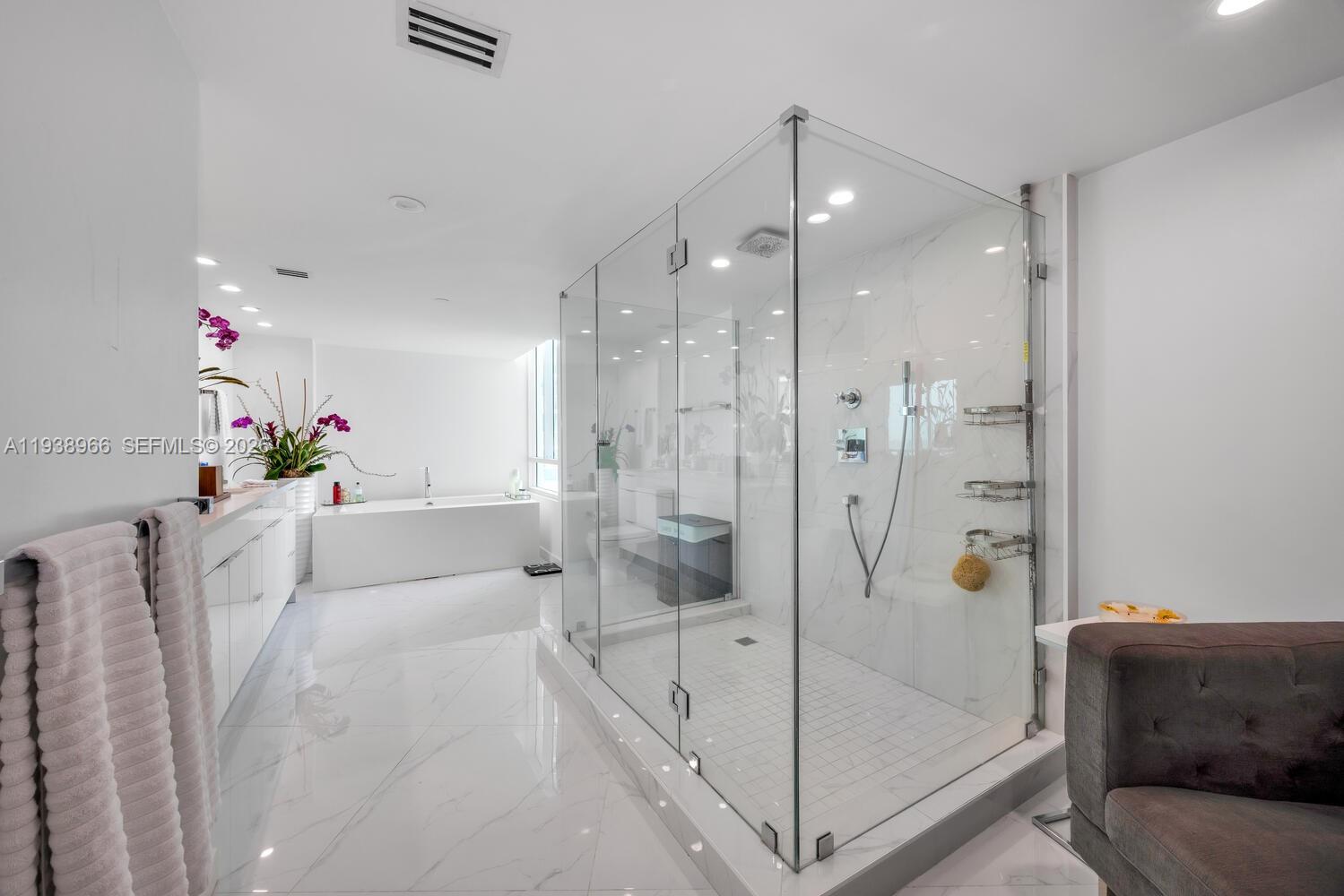 2127 Brickell Avenue, Unit 801 Miami, FL 33129 - Photo 18 of 38 a white bath tub sitting next to a shower