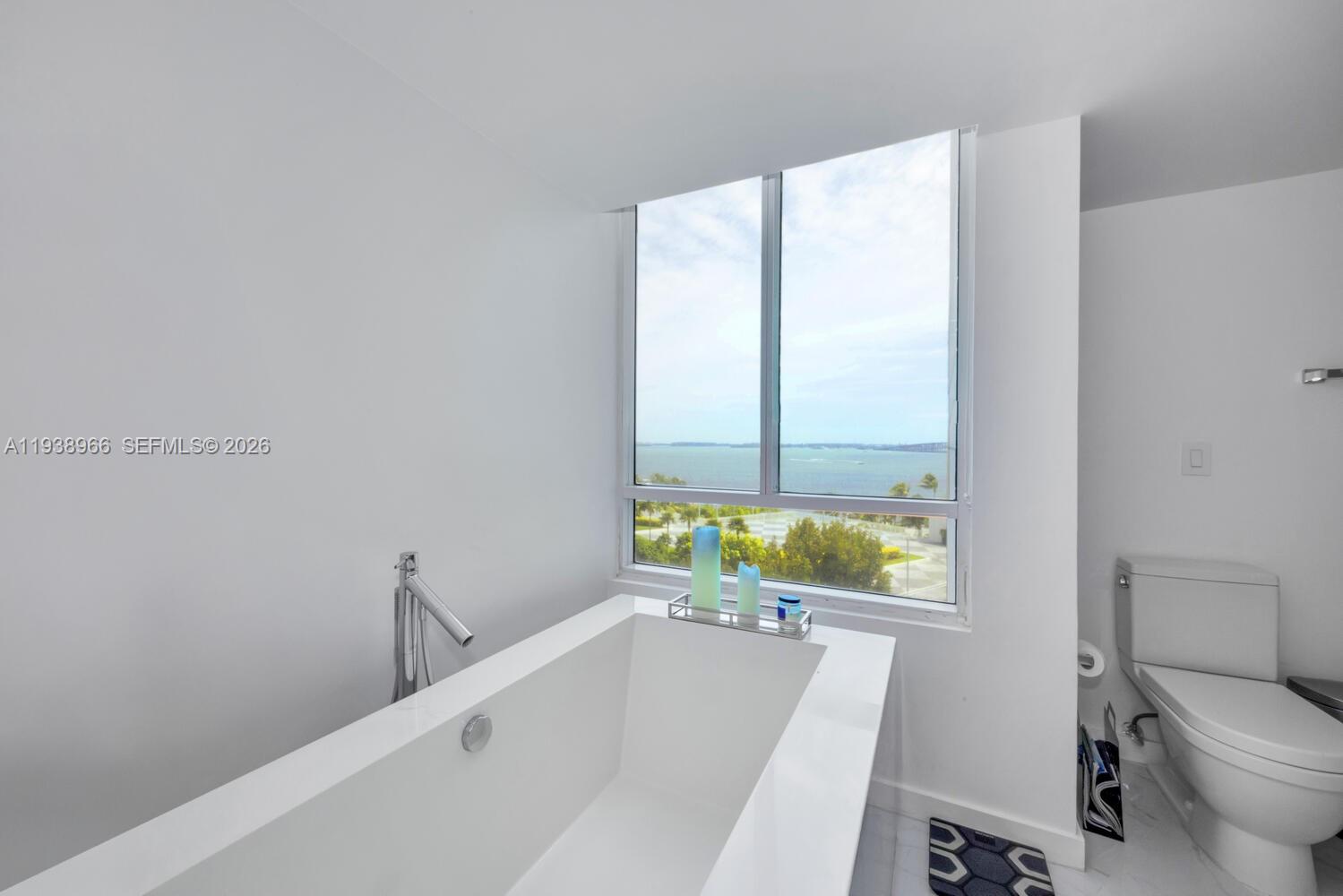 2127 Brickell Avenue, Unit 801 Miami, FL 33129 - Photo 19 of 38 a bathroom with a bathtub and a sink