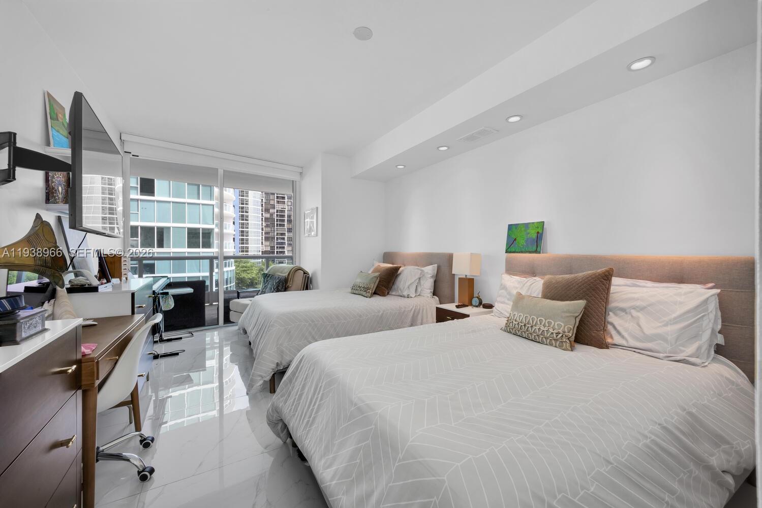 2127 Brickell Avenue, Unit 801 Miami, FL 33129 - Photo 20 of 38 a bedroom with two beds and a large window