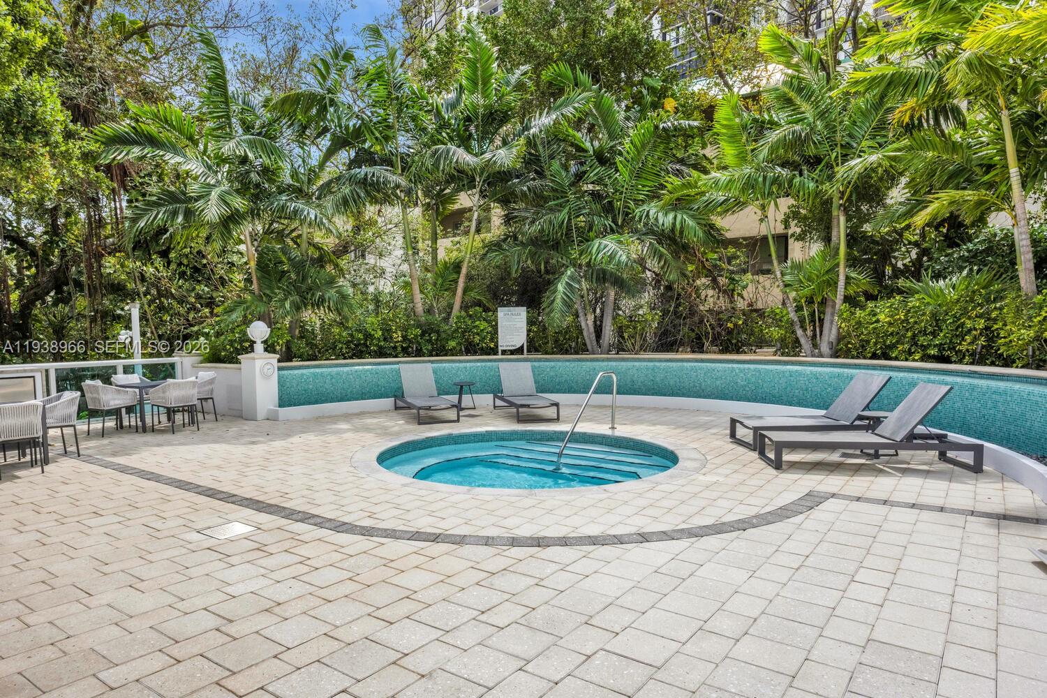 2127 Brickell Avenue, Unit 801 Miami, FL 33129 - Photo 31 of 38 a view of a backyard with table and chairs