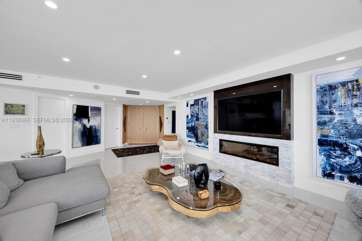 2127 Brickell Avenue, Unit 801 Miami, FL 33129 - Photo 7 of 38 a living room with furniture and a flat screen tv