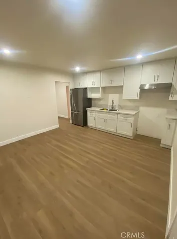 a large kitchen with kitchen island a sink stainless steel appliances and cabinets