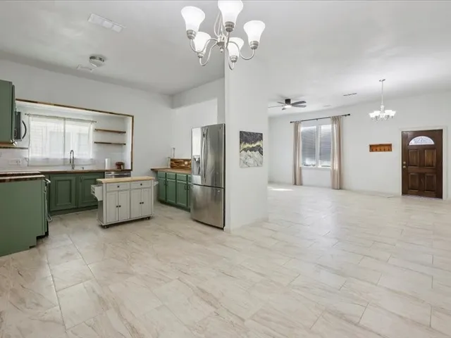 a kitchen with stainless steel appliances a refrigerator sink and cabinets