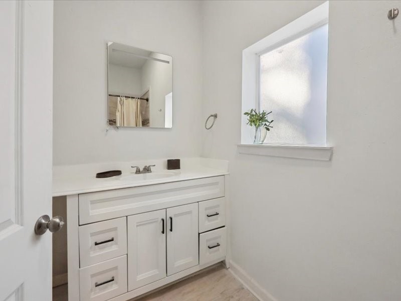2290 Orange Avenue Beaumont, TX 77701 - Photo 7 of 12 a bathroom with a sink and a mirror