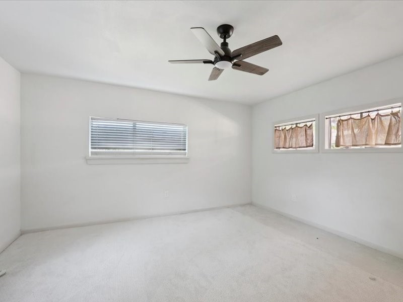 2290 Orange Avenue Beaumont, TX 77701 - Photo 8 of 12 a view of a big room with wooden floor and windows