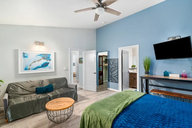 a bedroom with a bed and wooden floor