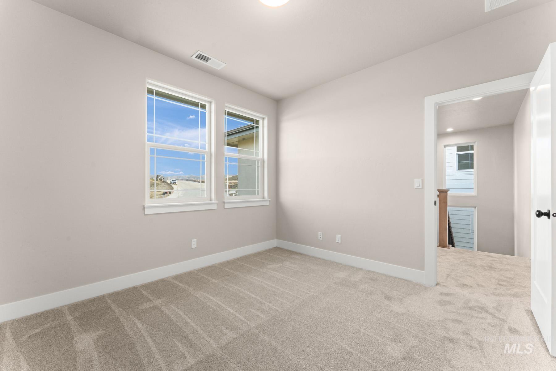 13366 North Spring Creek Way Boise, ID 83714 - Photo 24 of 44 Unfurnished room featuring light colored carpet and baseboards
