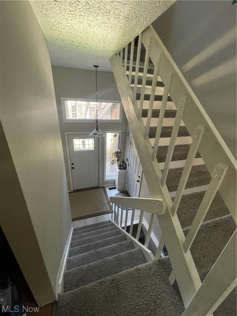 2408 Call Road, Unit 2B Stow, OH 44224 - Photo 12 of 32 Stairway featuring a textured ceiling and a high ceiling