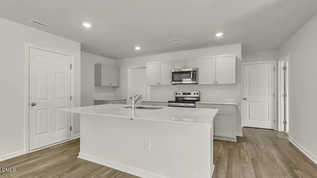 a kitchen with stainless steel appliances a sink stove and refrigerator