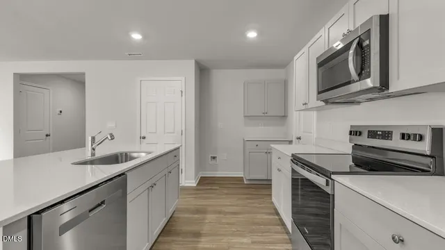 a kitchen with stainless steel appliances granite countertop a sink and a stove