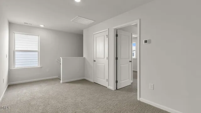 an empty room with windows and closet